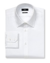 Slightly slimmer than a classic fit button front long sleeved shirt. Squarely beveled cuffs with two buttons. Flat back yoke with no pleats. Clean front, no pocket. Rounded hem. Solid broadcloth.