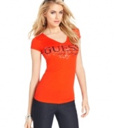 GUESS? makes jeans-and-a-tee look super sexy with this fitted top, featuring a bold hue and a graphic logo print at the bust.