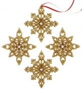 Let it show. Gold snowflake ornaments gleam from any branch thanks to a brilliant glitter finish and sparkling white center. With two distinct designs.