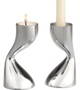 Light tapers or tea lights in this sensually sculpted pair of metal candlesticks. A mirrored finish reflects the flames, adding drama to a darkened room. Designed by acclaimed sculptor and interior and furniture designer Karim Rashid, Flow candlesticks continue the Nambé tradition of functional art.