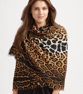 Lightweight and luxurious wool/cashmere knit finished with an oversized leopard print with eyelash fringe trim. About 55 x 71 70% virgin wool/30% cashmere Dry clean Made in Italy 