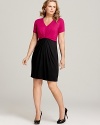Decadent fuchsia drapes down to a black skirt for an elegant take on trend-right color blocking.