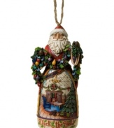 Christmas comes early in the elaborate carved skirt of Jim Shore's Deck the Halls Santa ornament. A picture-perfect holiday morning is topped with St. Nick, his arms full of colorful garland.