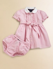 Sweet ruffles and a bow prettily accent the classic oxford shirtdress.Club collarShort puffed sleeves with single-buttonFront buttons with ruffle trimEmpire waist with a self-tie bowMatching bloomersCottonMachine washImported Please note: Number of buttons may vary depending on size ordered. 