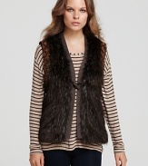 This plush GUESS faux fur vest flaunts ornately beaded armholes for a glamorous finish.