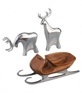 Add artisinal craftsmanship to your home this holiday with this set of two grazing reindeer and sleigh, crafted of lustrous  Nambé alloy and acacia wood. Designed by Todd Myers. The tallest reindeer stands 9-1/2 high. Both reindeer are 4 wide. The sleigh measures 11-1/2 x 3-1/4.