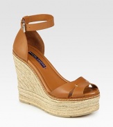 Richly hued leather set atop a textured espadrille wedge, secured by a wrap-around ankle strap. Hemp wedge: 4½Hemp platform: 1¼Compares to a 3 heelLeather upperLeather liningRubber solePadded insoleMade in Italy