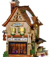 With its whimsical detailing and bright coloring, Swift's Stringed Instruments is a delightful building that helps keep the music alive at Christmastime. Crafted of hand-painted porcelain and part of the Dickens' Village from Department 56.