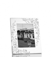 Etched with cascading florals, the silver-plated Trousseau picture frame from Martha Stewart Collection presents wedding photos and other sentimental moments with fresh elegance. With velvet backing.