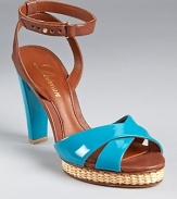 Glossy patent leather in a tropical turquoise hue lends warm weather style to a stunning pair of sandals from Delman.