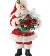 All the bells & whistles! With a decorative Christmas ball wreath in hand, this Santa figurine evokes the happiness associated with hanging holiday trim.