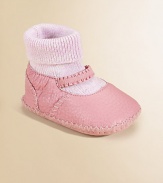 So precious in soft leather, lined in shearling to keep her toes toasty warm.Moccasin stitchingElasticized strapRibbed sock insertShearling liningLeather soleImported