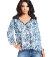 Sheer mesh insets and a colorful, ameba-like print band together seamlessly on this floaty day top from GUESS?.