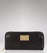 Lend your look contemporary polish with this python-embossed patent leather continental wallet from MICHAEL Michael Kors.