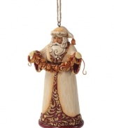 Dressed – not in his traditional red and white getup – but in a beautiful coat of ivory, burgundy and gold, this Santa ornament from Jim Shore makes for a memorably elegant tree.