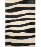 A suggested zebra stripe adds a hint of wild energy to the Spello Wavey Stripe area rug, while its tame color palette lends itself to any modern home décor. This unique home accent is intricately hand-tufted for crafted durability and supreme detailing in composition.