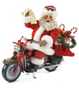 Look who's got a new set of wheels! Santa is delivering gifts on his decked out motorcycle, complete with festive ribbon, garland and stockings.