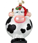 A whimsical cow gets a festive makeover complete with a Santa hat and holly embellishment. Hand-painted glass ornament from Christopher Radko.