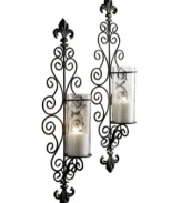 Spark drama in your foyer or living room with the Della Corte candle sconce set. Extravagant swirls of black metal capped with double fleur de lys lend modern-day romance to vintage-inspired decor.