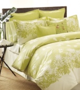 It's always greener. A modern print of botanical silhouettes transforms your room into a tropical oasis with Tommy Bahama's Paradise Isle comforter set. Featuring pure cotton. Includes white bedskirt finished with green trim. (Clearance)