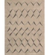 This visually arresting area rug has a simple design that casts striking shadows against a soft beige background. Hand tufted from 100% natural wool, this plush Calvin Klein rug is crafted using the cut-and-loop pile technique that creates a unique matte surface texture.