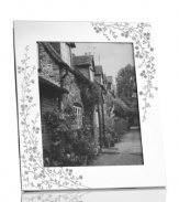 Etched with cascading florals, the silver-plated Trousseau picture frame from Martha Stewart Collection presents wedding photos and other sentimental moments with fresh elegance. With velvet backing.