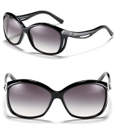 Balenciaga's chic oversized sunglasses feature a curving frame for a unique design.