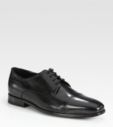 Distinguished leather lace-up with cap-toe finish.Leather upperPadded insoleRubber soleImported