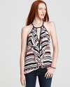 Ruffles cascade around a sexy keyhole cutout on this halter top, bringing a flirty counterpoint to the bold tribal print.