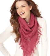 Let fashion be the window to your soul. Laid-back and lovely, this airy triangle scarf by Echo features worn patches.