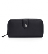 Zip around town with this zip-around frame wallet, full of nifty features, by Etienne Aigner.