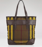 Burberry's signature check is refreshed for this season in a day-right shape and contrasting tones. This tote flaunts a modern ease that's ideal for the busiest of days.