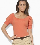 Imbued with breezy bohemian style, a soft cotton jersey top gets a romantic update with a smocked neckline and cuffs.