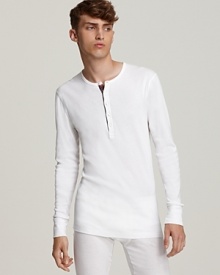 Luxe with a lean fit, this 2(x)ist long sleeve henley features a plaid piping at the placket. Pair it with matching long john pants for a superbly cozy set. Luxe with a lean fit, this 2(x)ist long sleeve henley features a plaid piping at the placket. Pair it with matching long john pants for a superbly cozy set.