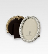 A keepsake accent for life's favorite moments and people, upholstered in smooth leather with gold- or platinum-plating and glimmering Swarovski crystals. Accommodates a 2 X 3 round photograph Hand wipe Imported