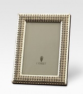 Memories are cherished like jewels, so it's only fitting that a photograph sit within a frame inspired by fine jewelry with hand-applied Swarovski crystals and fresh-water pearls. From the Perlée Collection Accommodates a 8 X 10 photograph Brass with Swarovski crystals & fresh-water pearlsBeveled glass, satin liner, leather backImported