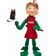 A soda jerk delivers a different type of holiday bubbly in this retro figurine for Coca-Cola collectors. Crafted with the soft, flexible features and unmistakable style of Annalee.