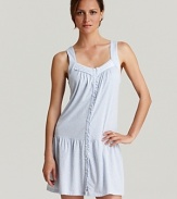 A sleeveless chemise with a lace pleated V-neckline and button front.