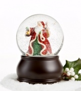 Deck the halls! Santa Claus, dressed in glittery garb, treks through the snow with his bag of gifts and lantern to light the way in this snow globe sure to bring cheer to your home.