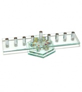 Combine Hanukkah candle lighting and dreidel fun with one festive menorah. A row of silvertone metal candle holders set in glass and perched on six colorful tops raises everyone's spirits for eight days straight.