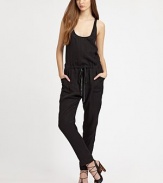 This statement-making one-piece is cinched at the waist by a rich leather drawstring and finished with a skin-baring crossover back.ScoopneckSleevelessBlouson bodiceDrawstring waistSlash pocketsCrossover backRise, about 10Inseam, about 2959% cupro/41% lyocellDry cleanImportedModel shown is 5'10 (177cm) wearing US size 4.