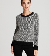 Touchably textured, this DKNY sweater flaunts an oversized stitch for a quirky-cool approach to everyday style. Toughen the soft silhouette with sleek skinnes for downtown edge.