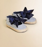 A great big striped bow with touches of sparkle adorns the front of a sweet denim sneaker with jute trim.Cotton denim upperJute edgingBack ankle zipper for easy on and offStriped fabric liningPadded insoleDenim soleImported