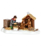 A calming hush falls upon this scene as a festively dressed man lovingly and tenderly prepares the manger of his New England village's nativity. This porcelain figurine captures the anticipation, excitement and reverence of the holiday season.