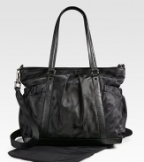 A large, nylon carryall for baby and mom with requisite checks, plenty of pockets, compartments and a matching changing pad.Double top handlesDetachable, adjustable shoulder strapTop zip closureElasticized side pocketsOpen inside pocketElasticized inner pocketTwo elasticized side bottle holdersFully linedAbout 13H X 15W X 6DNylon with leather trimSpot cleanImported