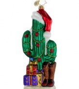 Deck the desert. A cacti in a Christmas hat, plus a pair of cowboy boots and longhorn-patterned wrapping paper make this hand-painted ornament essential to holidays in the American Southwest. By Christopher Radko.