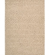 A blizzard of soft spots linger in between imperfect lines, creating beautiful harmony against a gentle sand-hued ground. Hand tufted from 100% natural wool, this plush Calvin Klein rug is crafted using the cut-and-loop pile technique that creates a unique matte surface texture.