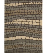 At once rustic and chic, Nourison's Fantasy rug is a stepping stone to great contemporary style at home. Hand-hooked of high-density fibers, the rug features a cobblestone-inspired pattern in tonal slate greys, lending an earthy, elemental feel to any space.