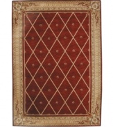 Infusing classic design with modern flair, this rug features a striking lattice pattern studded with rosettes on a deep sienna ground, bordered with floral and vine accents. A premium wool weave imparts rich texture and indulgent softness.