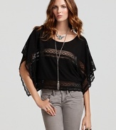 Accent your alluring features in this Free People top featuring sheer lace insets throughout the silhouette. Flutter sleeves lend added femininity to the boxy silhouette, which elevates daily denim from simple to sensational.